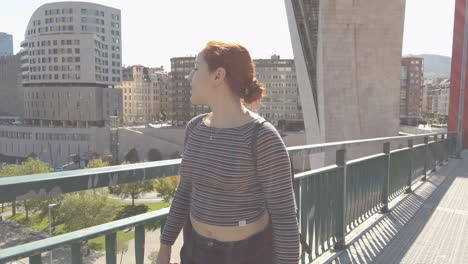 woman on a bridge in the city