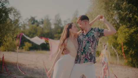 young man and woman dancing bachata at beach