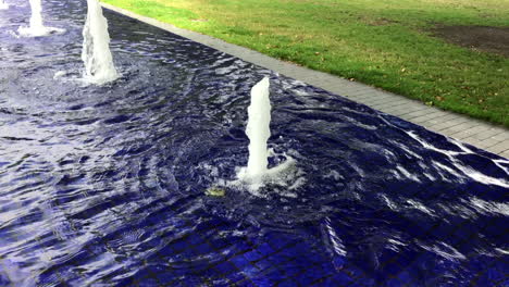 blue fountain in the city park