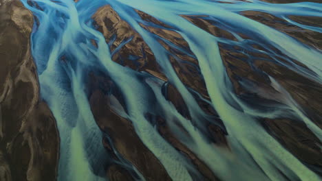 kalfafell river braids, iceland - an up-close observation of a river - orbit drone shot