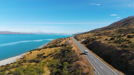 van driving on road near lake pukaki on south island of new zealand