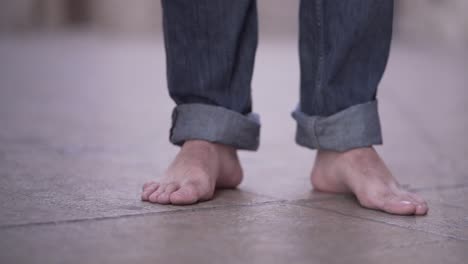 barefoot person walking on stone floor