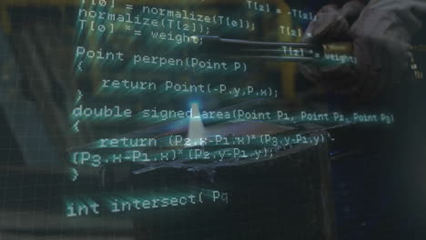 male welder operating torch in technology workshop, displaying animated code overlay and sparks