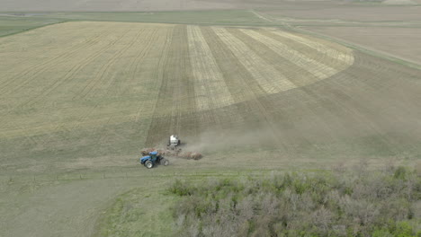 big tractor with seeding equipment turning around on headland in zero-till field