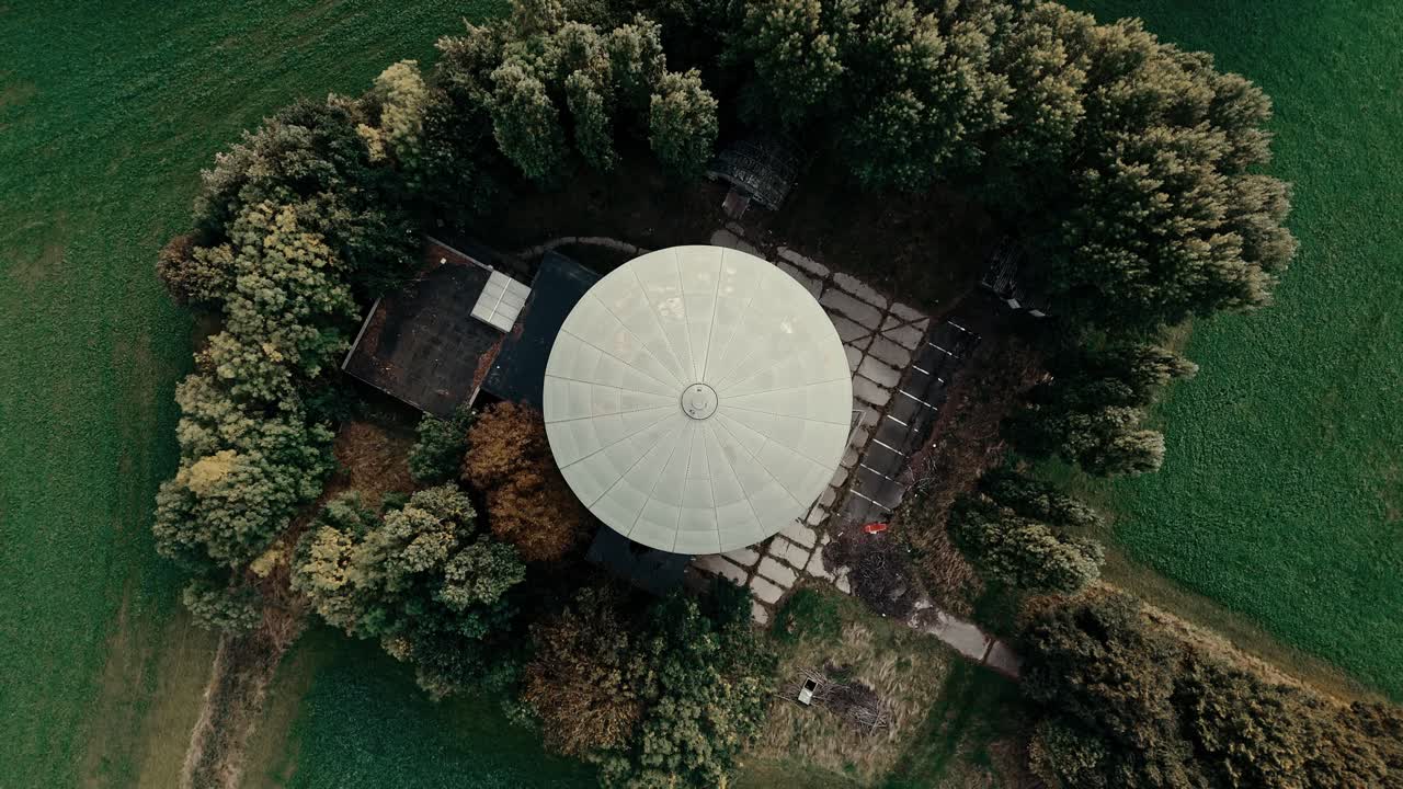 Aerial Top Down View of a Radar Dome Surrounded by Forest