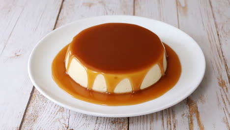 Delicious Flan with Caramel Sauce on a White Plate