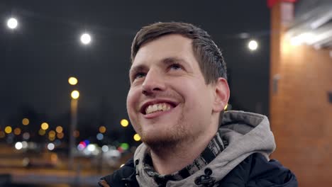 confident and smiling young caucasian male in closeup, enjoys life