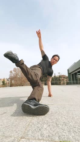 breakdancer performing freeze move variations in urban setting