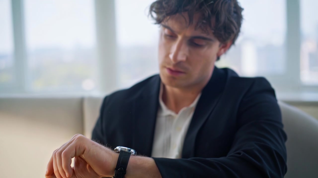 Man checking wristwatch waiting appointment. Hand watch closeup luxury office.
