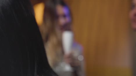 Close-Up-Shot-of-Group-of-Friends-Dancing-Together-at-a-Bar