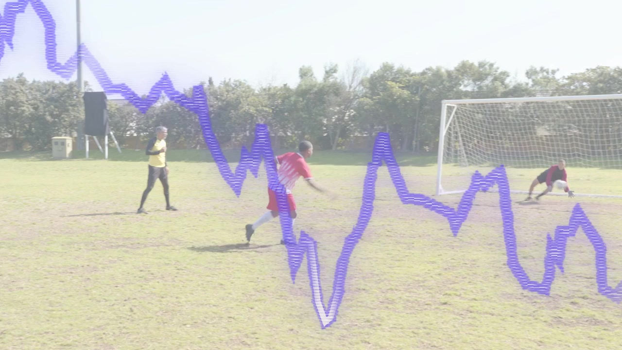Red soccer kicker placing ball running shooting aiming goal keeper diving purple overlay obscuring