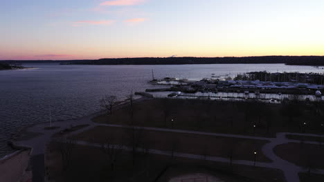 an-aerial-shot-over-an-empty-park-focused-on-the-bay-during-a-beautiful-sunrise
