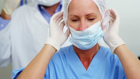 Dentist-and-dental-assistant-wearing-surgical-mask