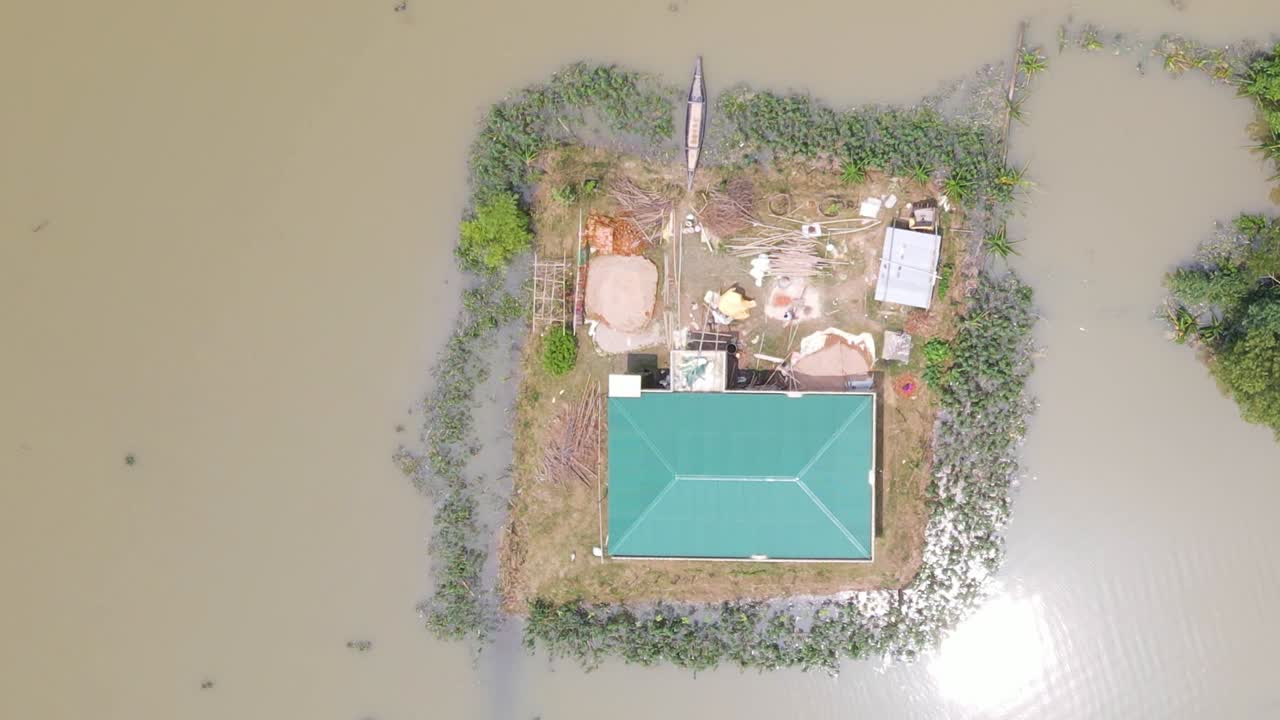 Rural Houses surrounded by flood water in a village in Bangladesh. Aerial top down view
