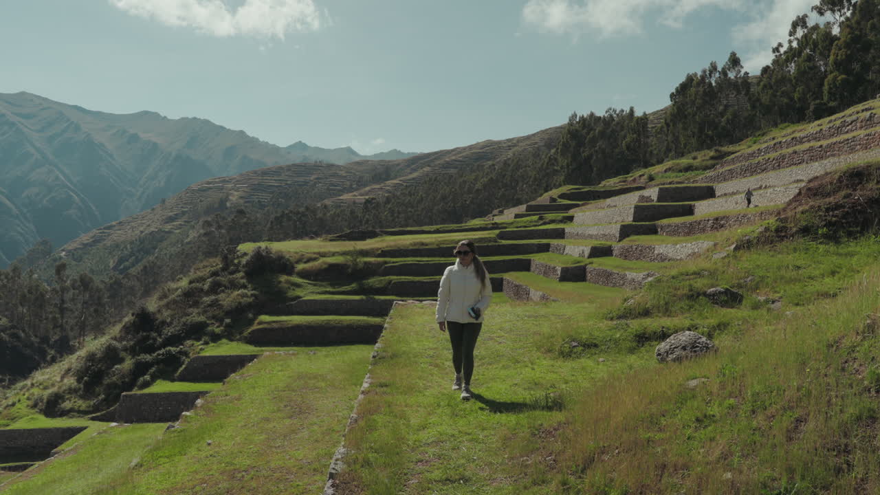 Woman Walking Through Ancient Agricultural Terraces in the Mountains