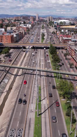 vertical drone shot of busy avenue traffic in el campin neighborhood of bogota, colombia