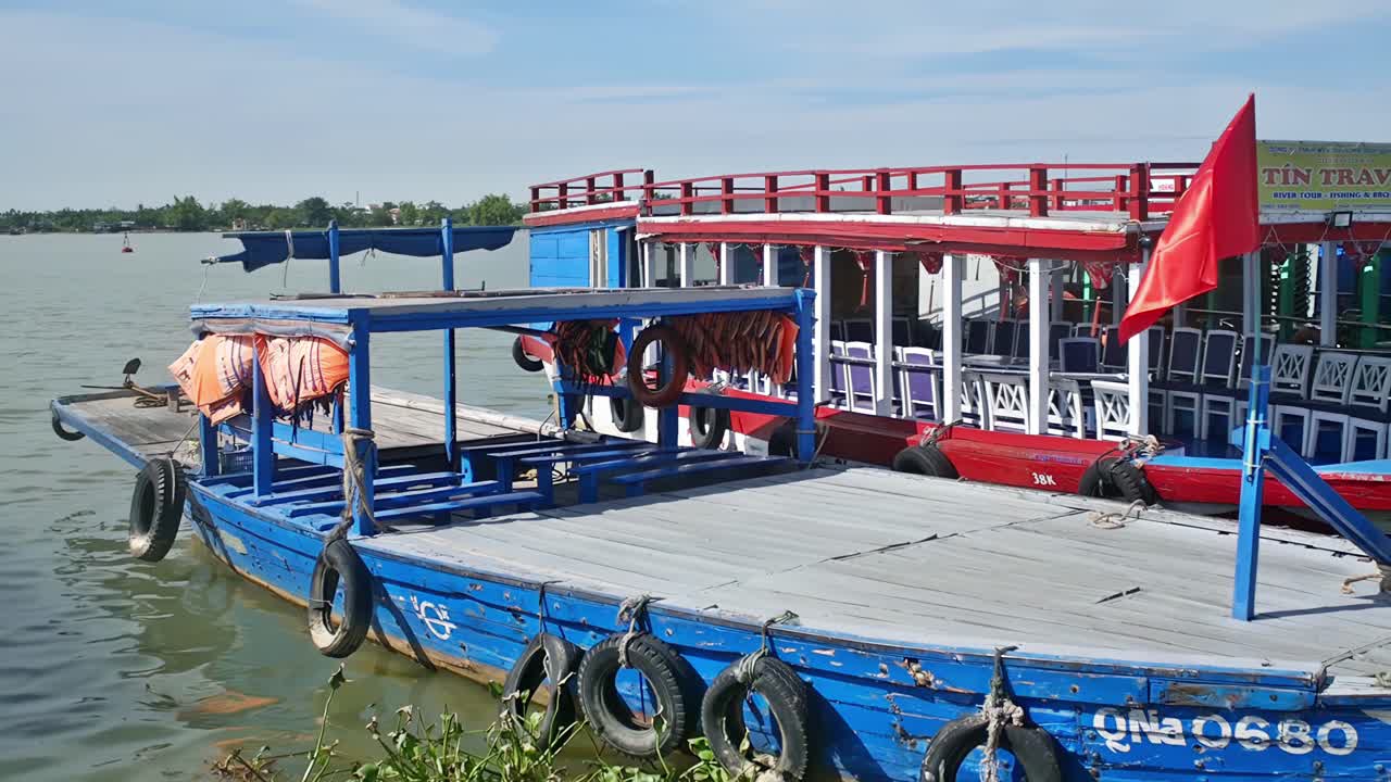 Berthed motor launches waiting to take tourists to locations outside of the Old Town section of Hoi An, Vietnam