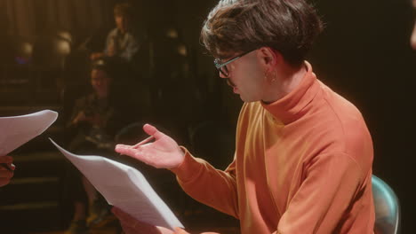 stage director leading rehearsal with theater actors