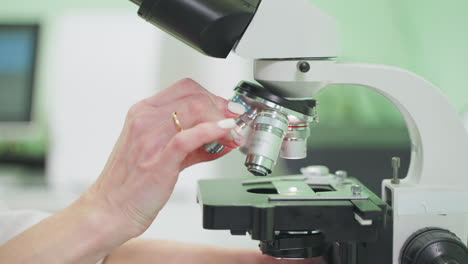 scientist using a microscope in a laboratory