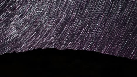 Nighttime-star-trails-time-lapse-shows-how-the-Earth-rotates---red-lines-are-from-planes,-includes-one-meteor