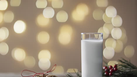 video of christma cookies, glass of miljk and copy space on wooden background