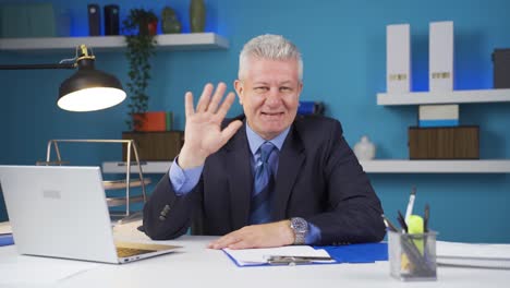 cheerful and happy happy businessman waving at camera.