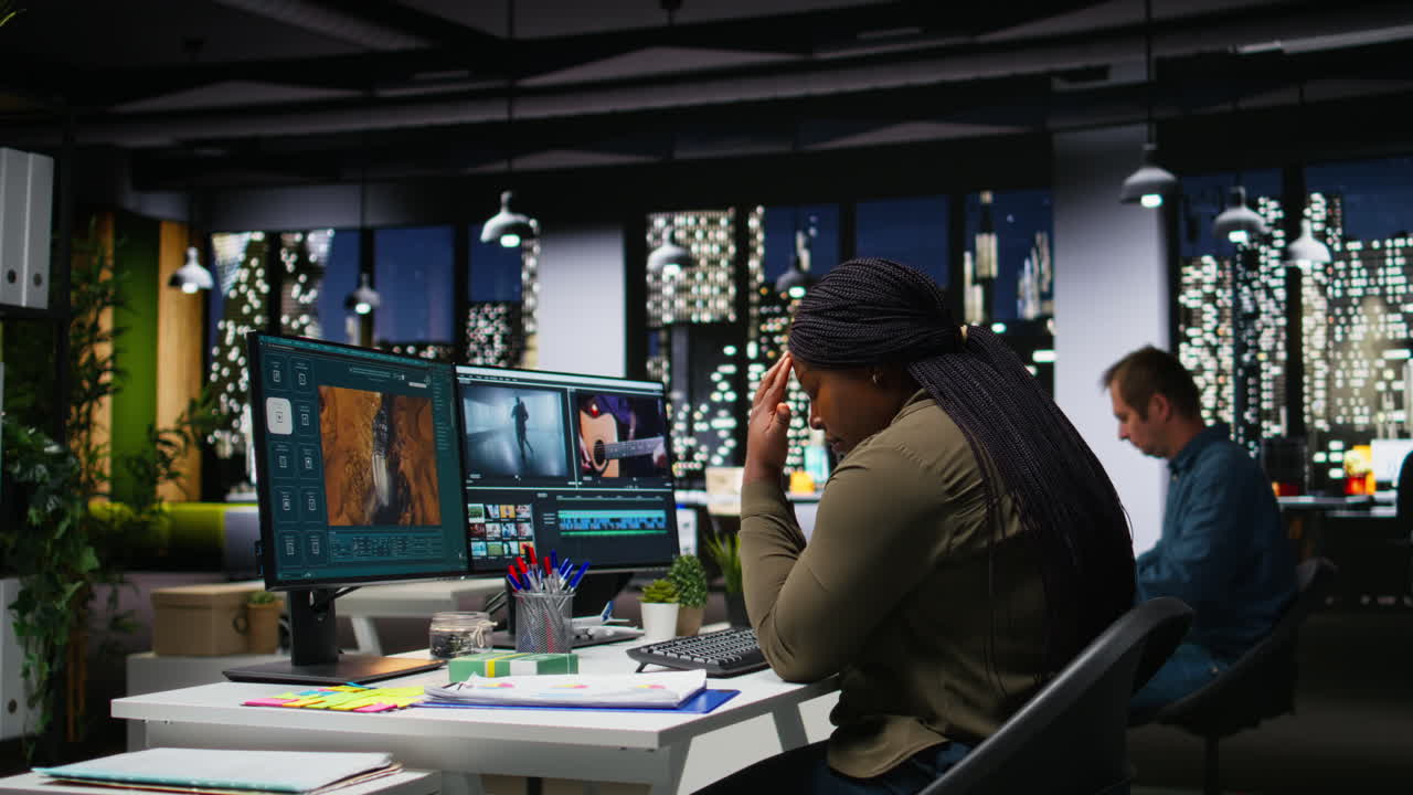 Fatigued drained videographer works on film montage with migraine