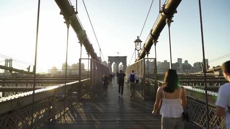 walking the brooklyn bridge at sunset
