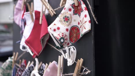 handmade face masks for sale on a board close up tilting shot