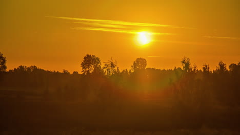 bright sunrise above green vibrant rural landscape, time lapse view