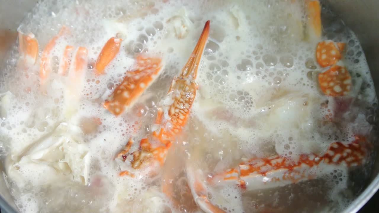 The cooks cook crab soup. Crab soup is cooked in a saucepan and stirred slowly for cooking evenly. Cooking ingredients included in stages