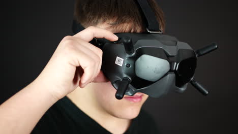 close up of young man touching buttons on vr goggles headset