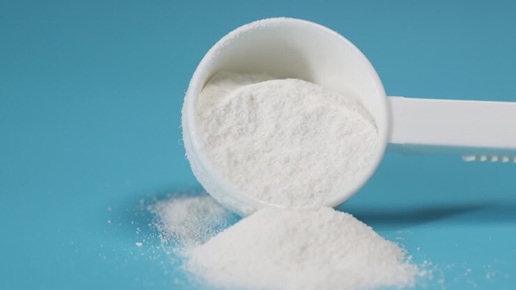 Closeup of a white protein powder scoop