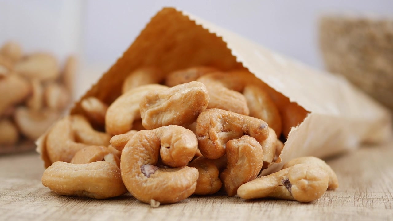 Roasted Cashew Nuts Spilling Out of a Paper Bag