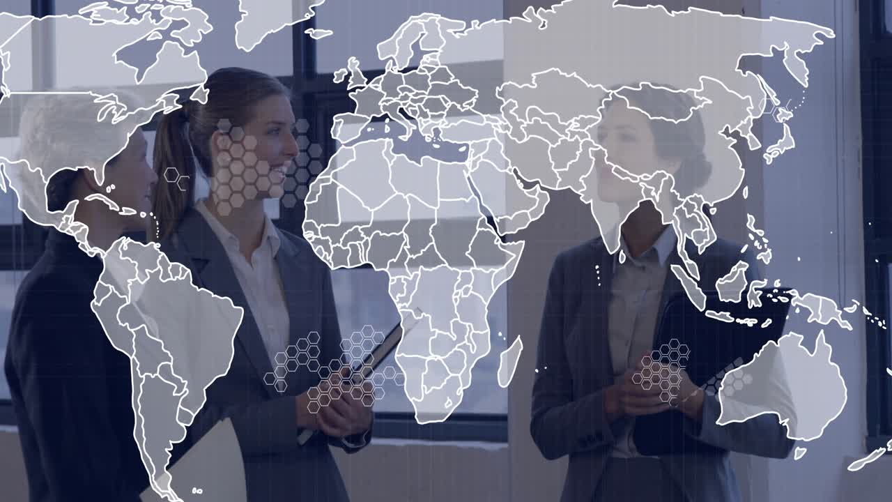 Three businesswomen tapping tablet and gesturing as animated world map gaining detail for briefing