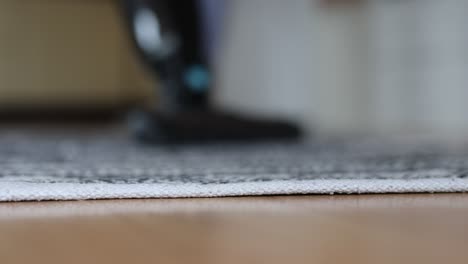 unrecognizable-woman-mopping-the-hardwood-floor-in-the-living-room