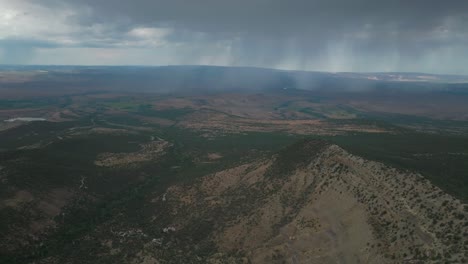 raining lands end hill climb grand mesa grand junction colorado aerial drone summer morning clouds thunderstorm rain sunny western slopes delta montrose olathe shade dark forward pan up motion