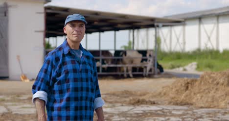 Farmer-Gesturing-While-Writing-On-Clipboard-Against-Barn-25