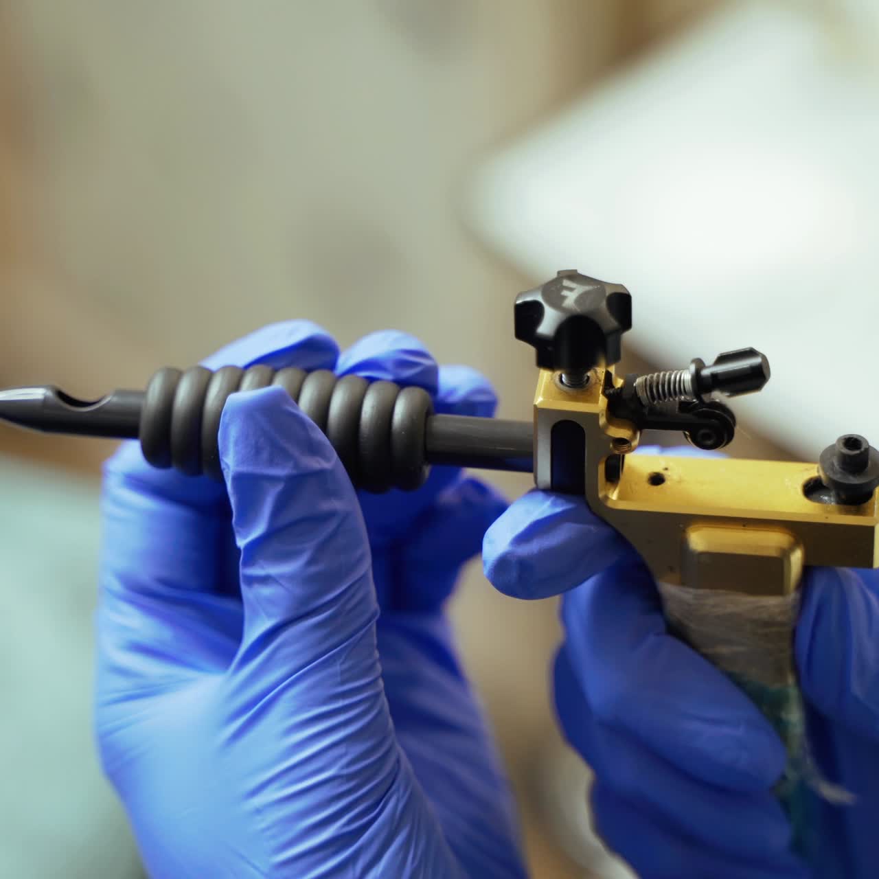 A beauty master is holding a machine for permanent make up in his hands in a beauty studio on a blurred background. Close-up
