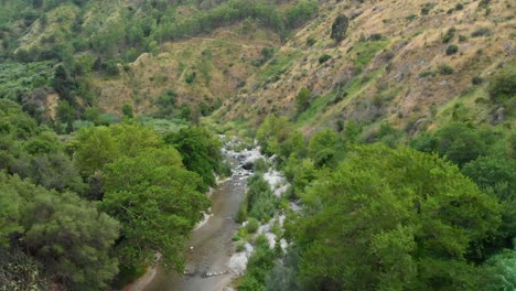 4K-AERIAL-DOLLY-IN:-Drone-flying-above-Alcantara-Gorges,-an-impressive-channel-of-lava-columns-eroded-naturally-into-ravines,-canyons-and-caves