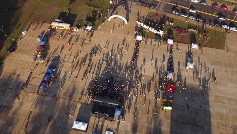 top down aerial view of gathering of people at an afternoon festival in posadas, misiones, argentina