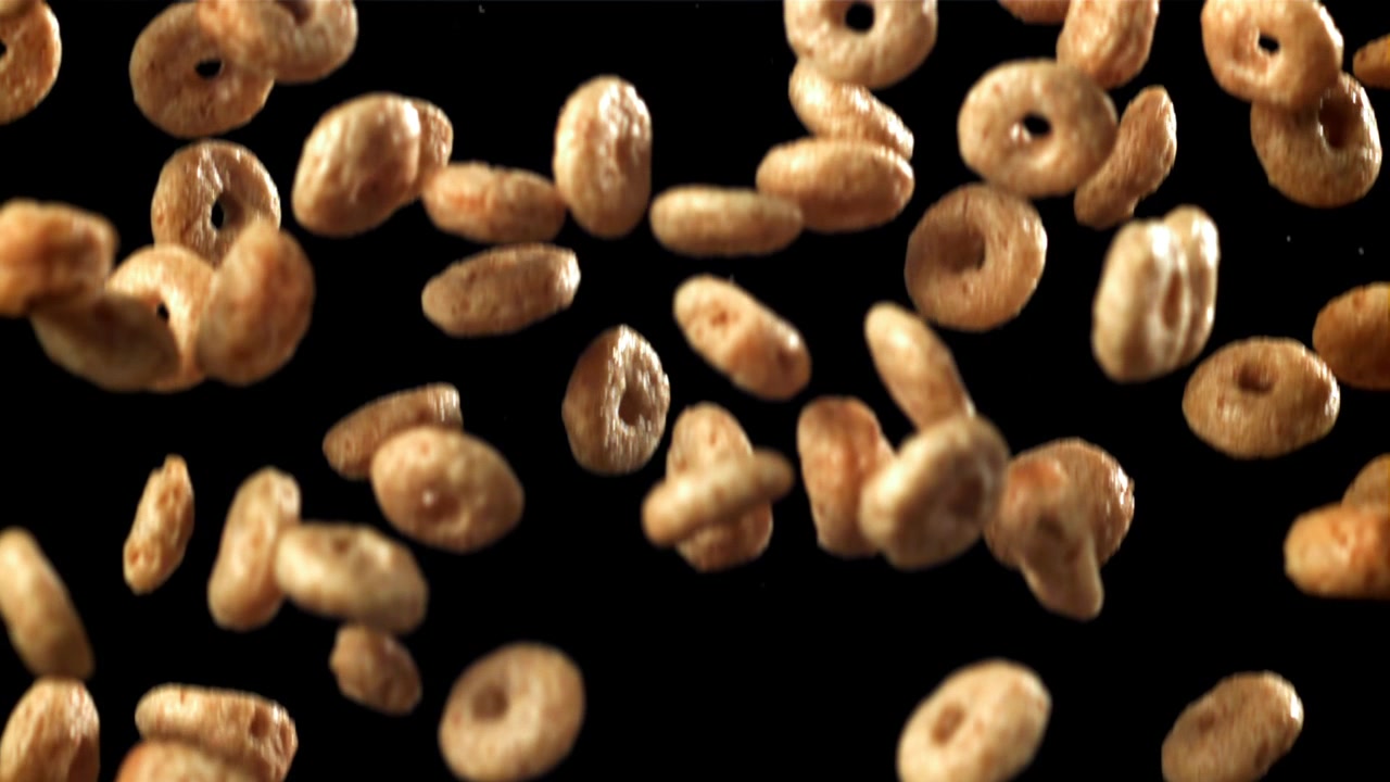 Breakfast Cereal Pieces Falling in Slow Motion Against Black Background