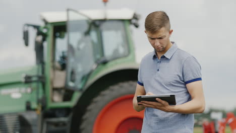 A-Young-Caucasian-Farmer-Is-Working-In-The-Field-With-A-Tablet-1