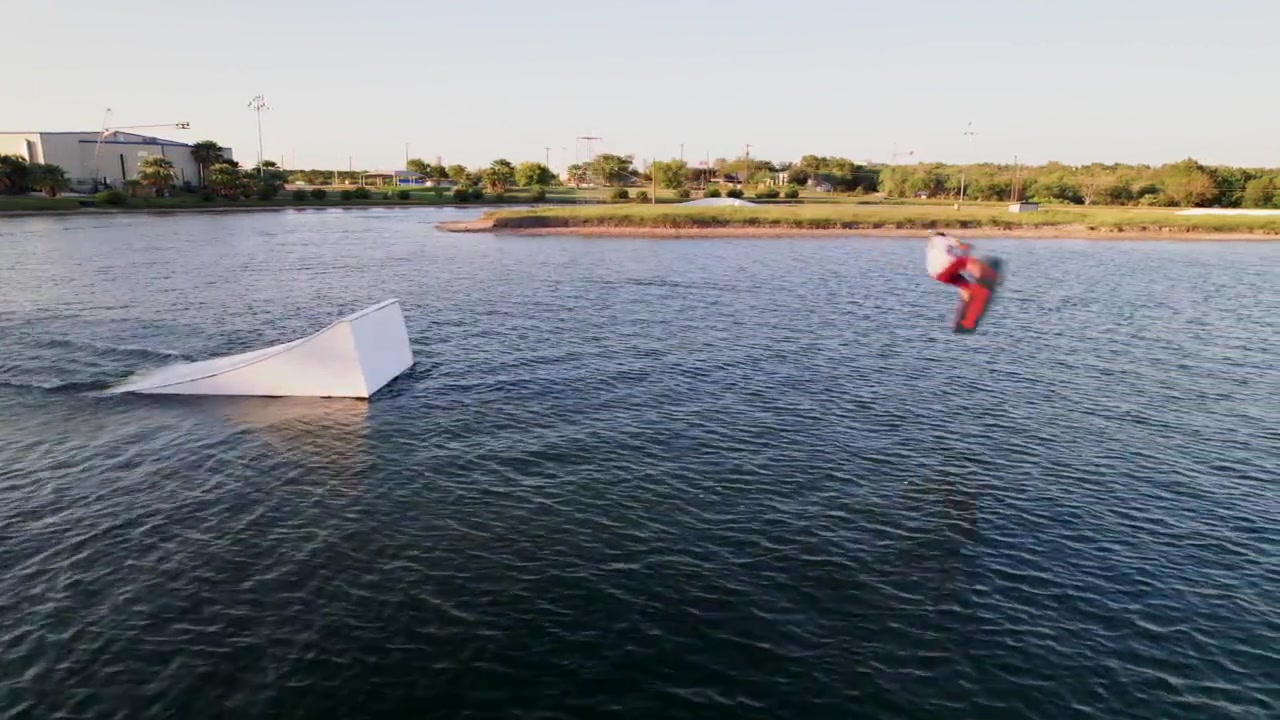 Aerial view of Aerial view of action sport athlete wakeboarding at cable park