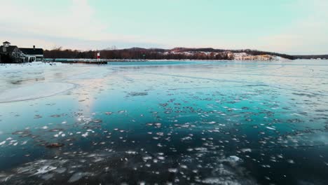 Low-height-aerial-push,-film-look-highlighting-icy-blues-and-greens