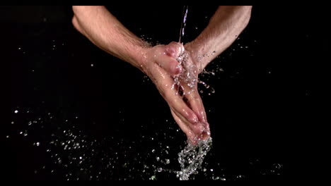 man washing his hands under stream of water