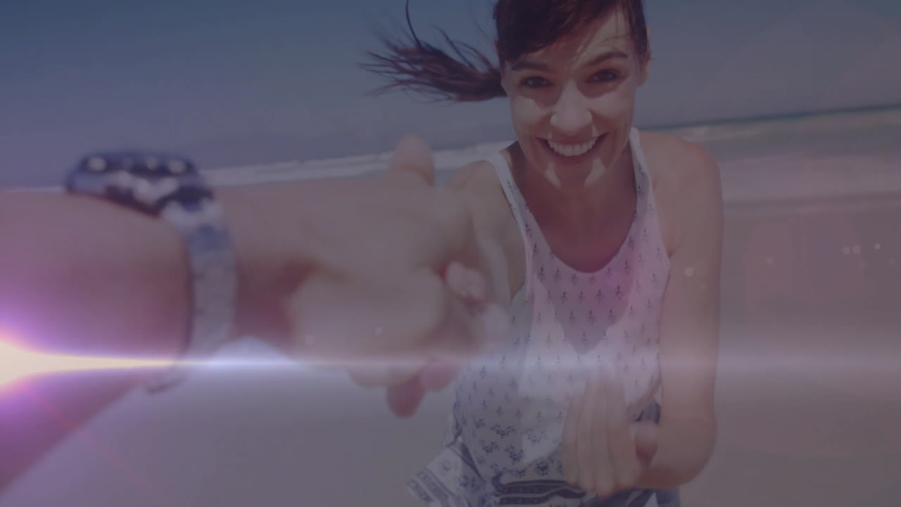 Holding hand on beach, woman smiling with light flare effect animation