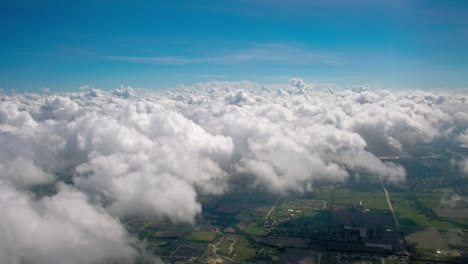 view from above the clouds to the horizon and the landscape below