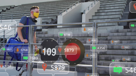 animation of social media icons and numbers over caucasian man wearing face masks in stadium