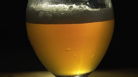 blond beer bubbling in glass